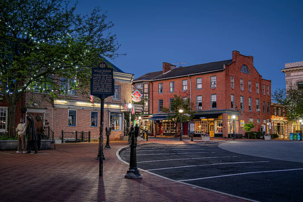 Historic Gettysburg PA at dusk, IT management services, and trees with lights. Sign reads Wills House.